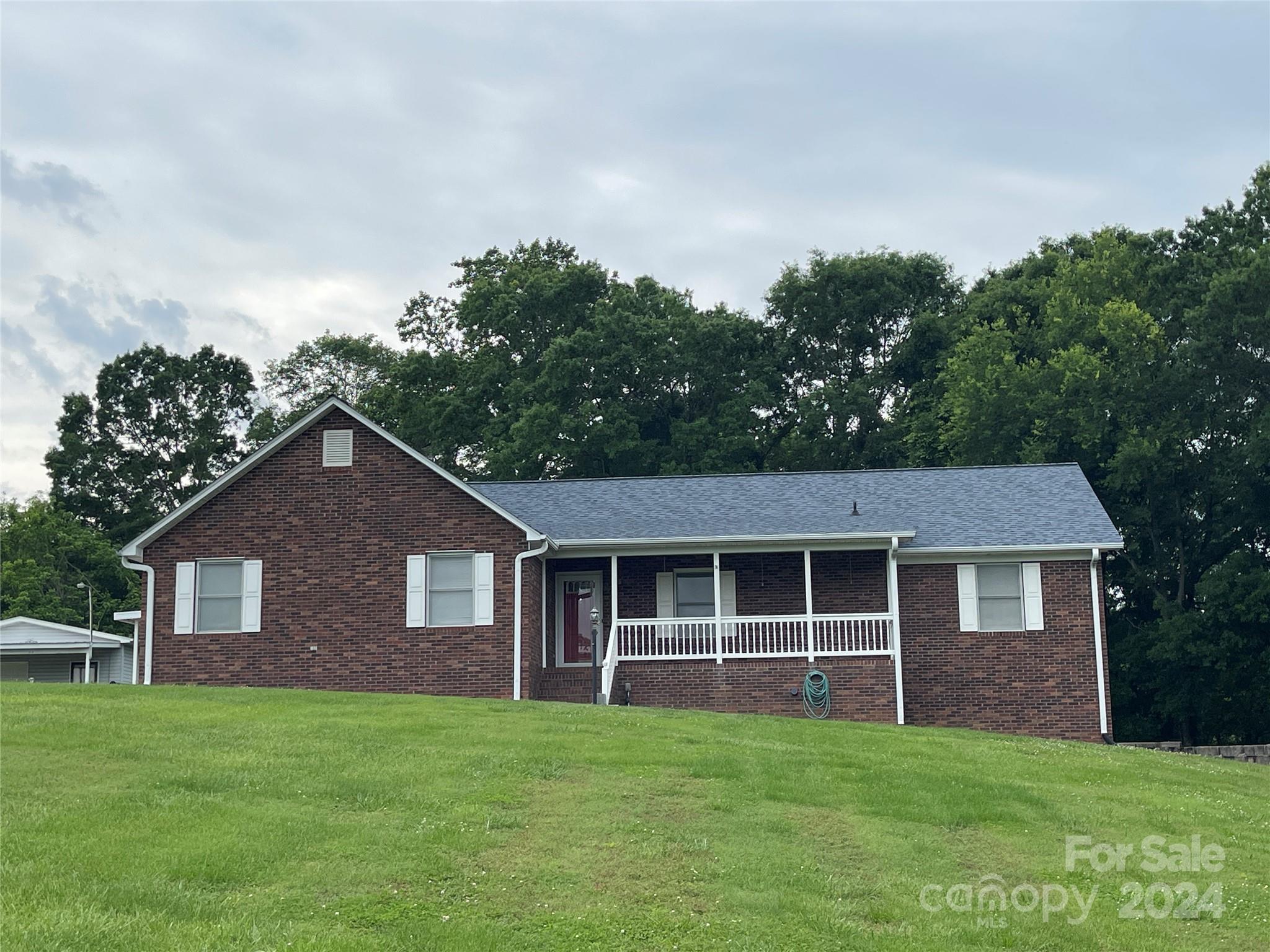 36345 Old Salisbury Road New London, NC 28127 - Photo 4 of 48 a front view of a house with a garden