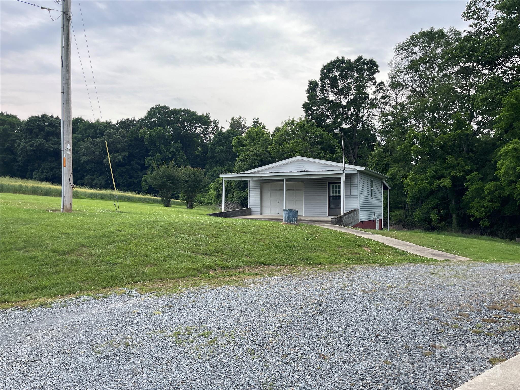 36345 Old Salisbury Road New London, NC 28127 - Photo 41 of 48 a view of a house with backyard and trees