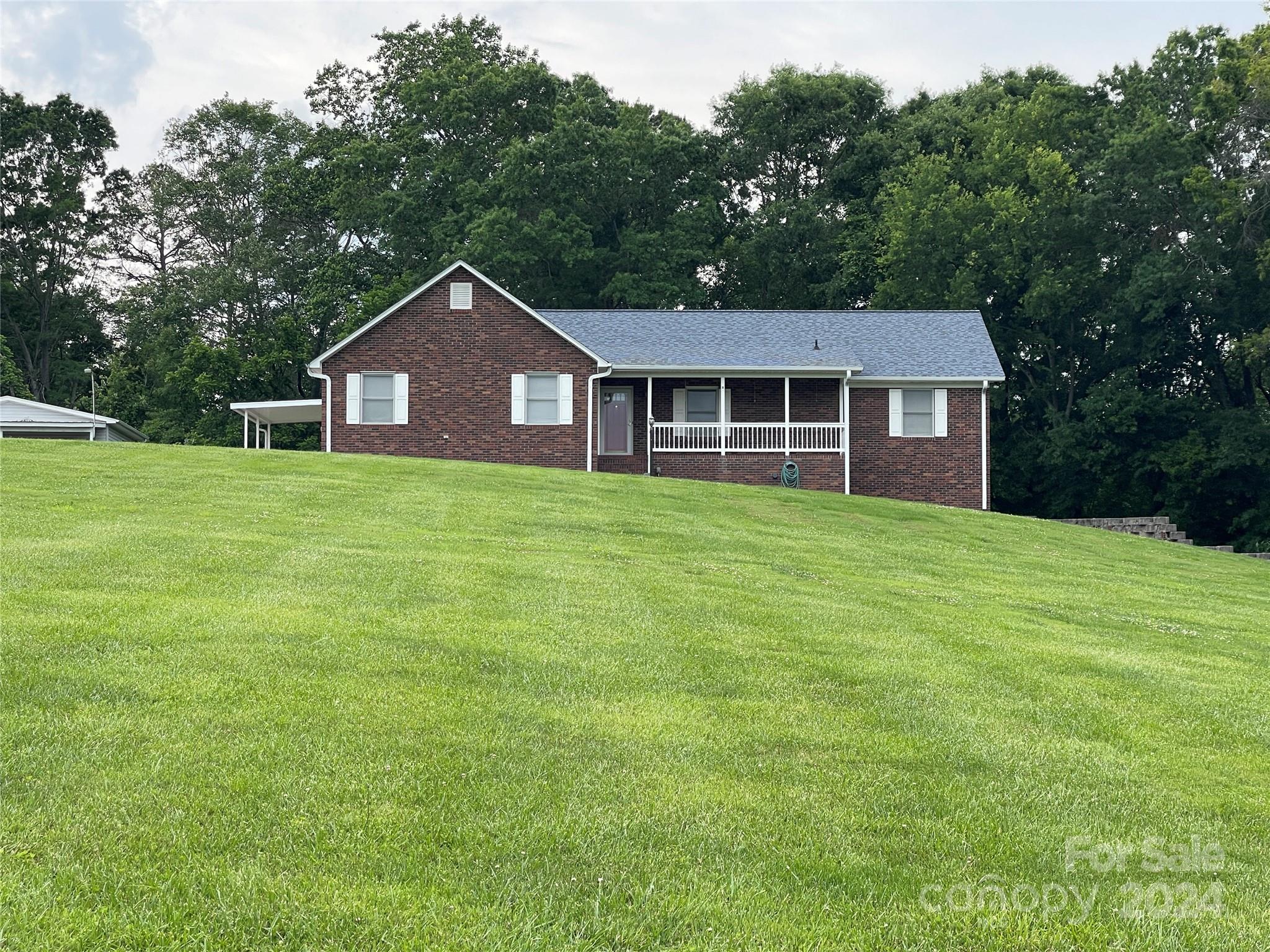 36345 Old Salisbury Road New London, NC 28127 - Photo 48 of 48 a house with a big yard and large trees