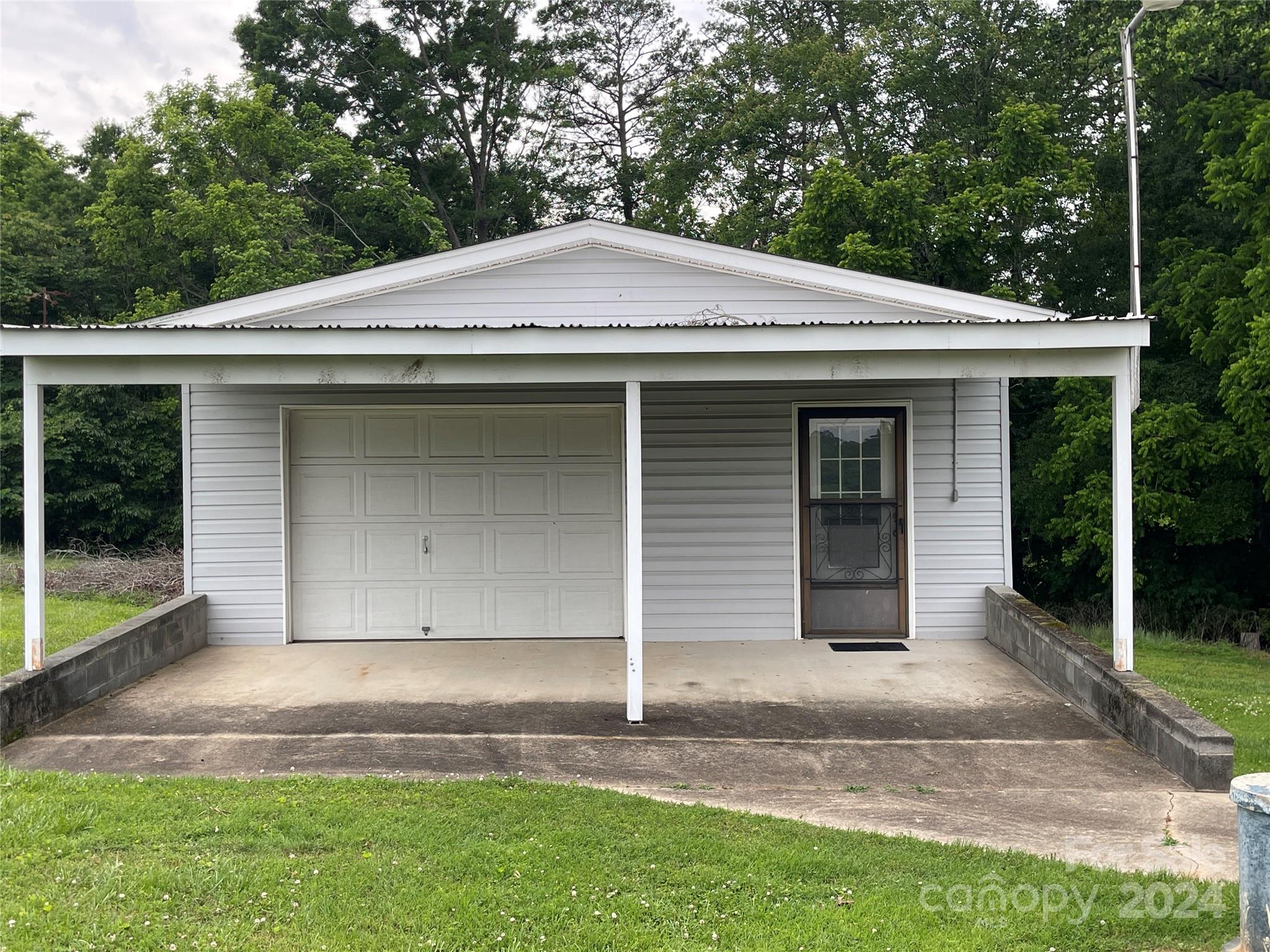 36345 Old Salisbury Road New London, NC 28127 - Photo 5 of 48 a front view of a house with a garden