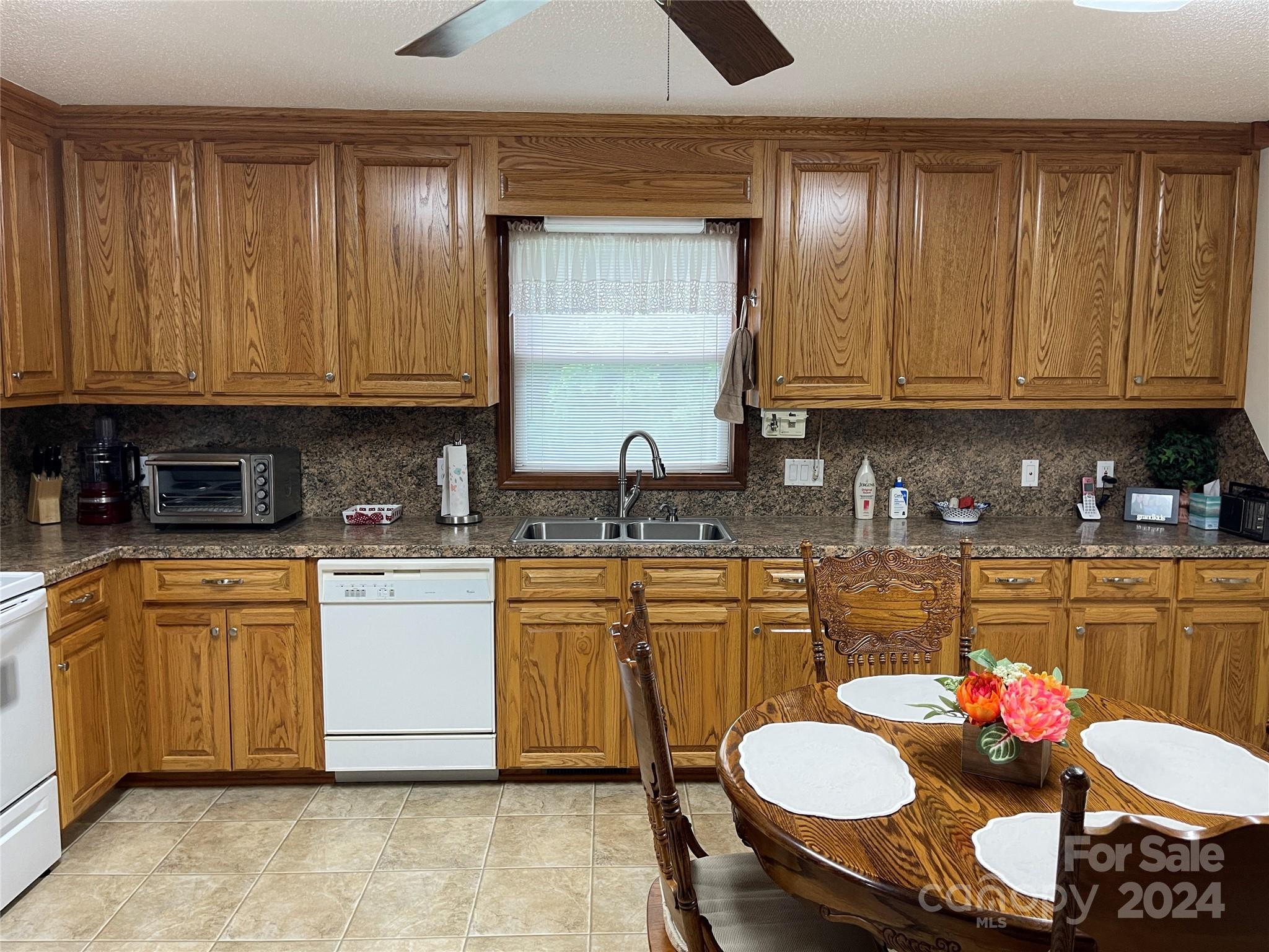 36345 Old Salisbury Road New London, NC 28127 - Photo 6 of 48 a kitchen with granite countertop a sink and white cabinets