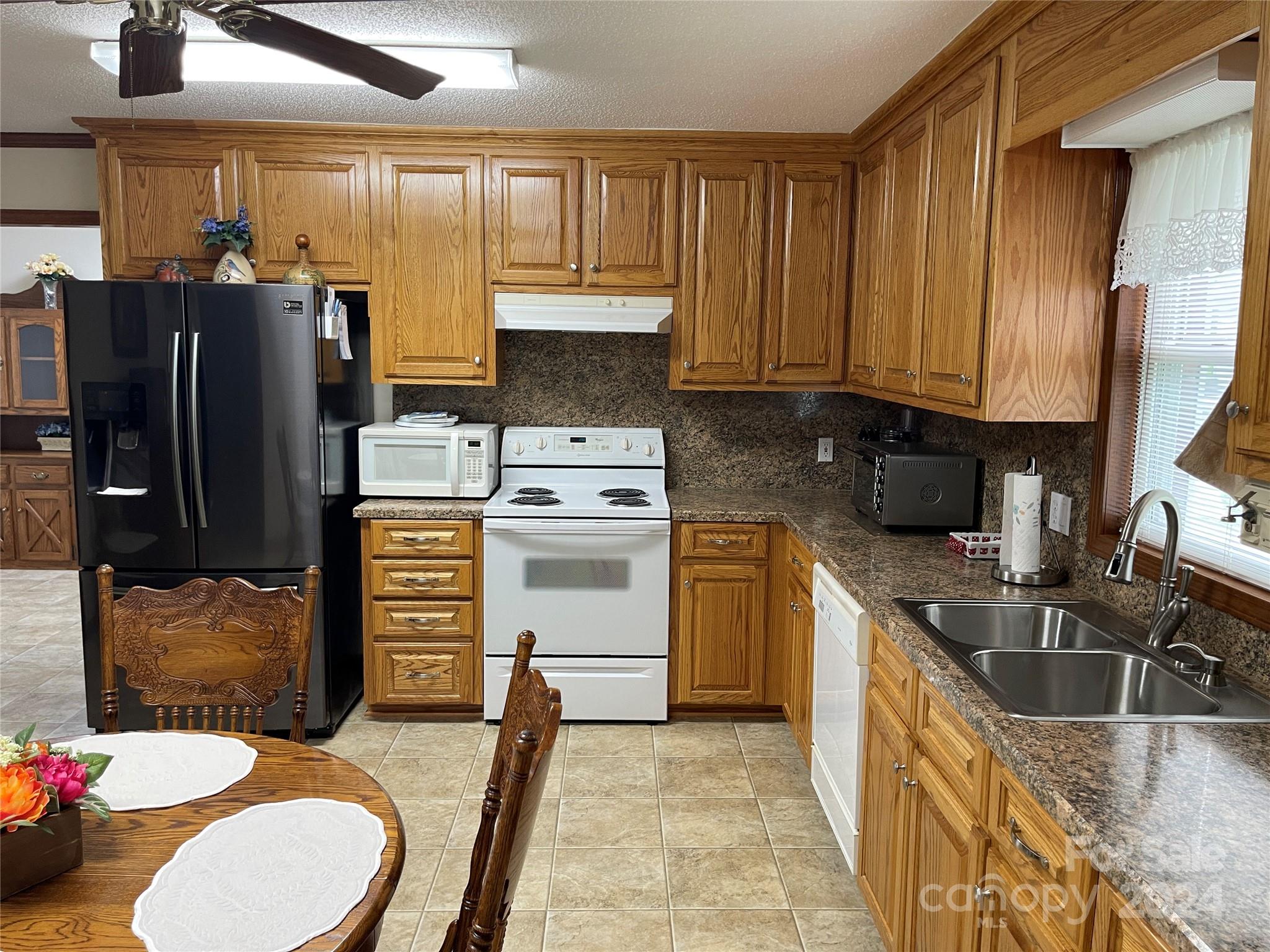 36345 Old Salisbury Road New London, NC 28127 - Photo 7 of 48 a kitchen with stainless steel appliances granite countertop a sink refrigerator stove and microwave