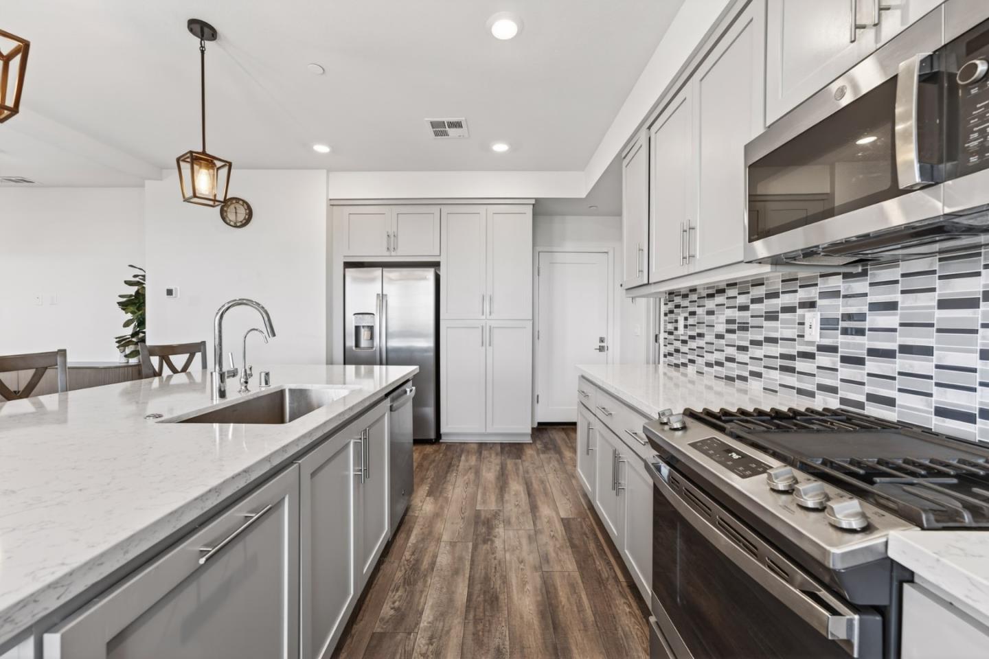 9532 Seawind Way Newark, CA 94560 - Photo 9 of 44 a kitchen with sink stove and cabinets