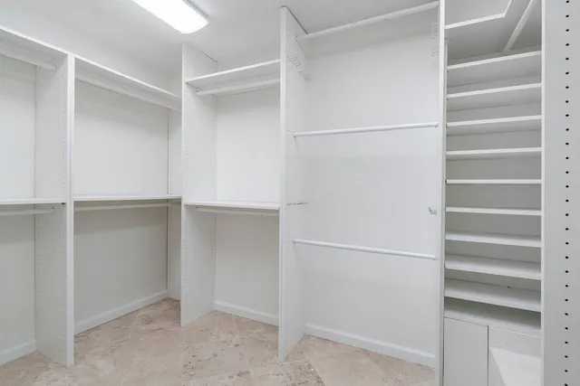 a view of walk in closet with empty racks