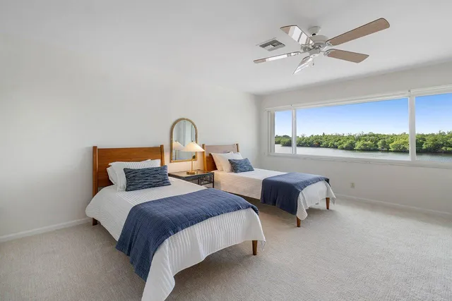 a bedroom with bed and a chandelier
