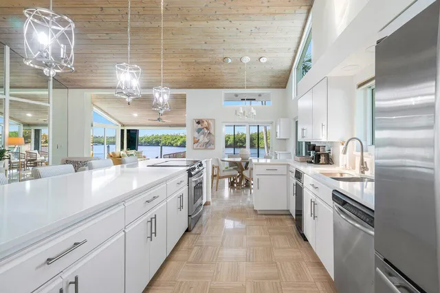 a large white kitchen with lots of appliances