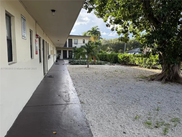 a view of a street with a trees in the background