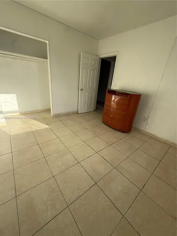 a kitchen with a refrigerator and a stove