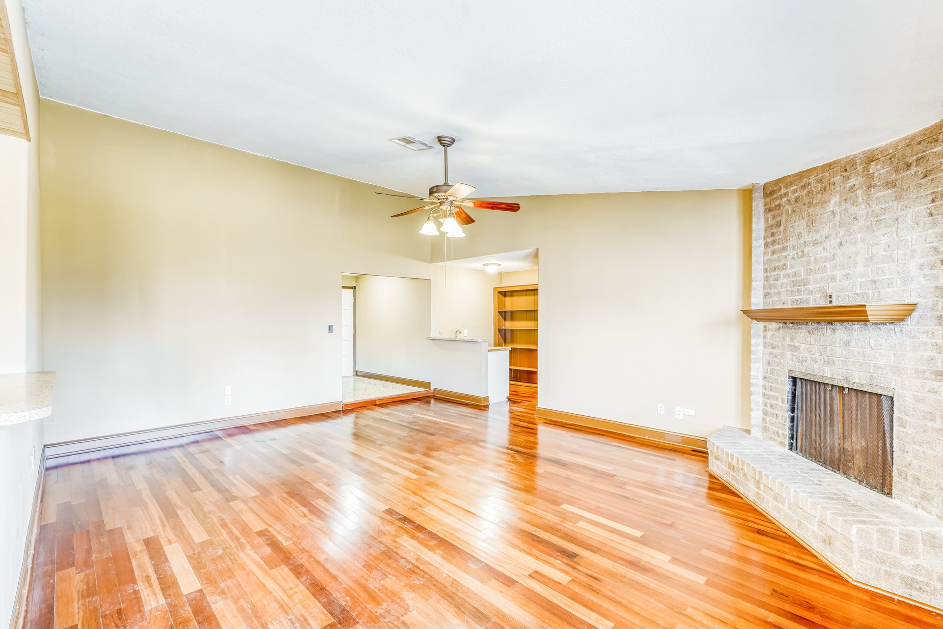 21611 Glenbranch Drive Spring, TX 77388 - Photo 2 of 15 a view of an empty room with wooden floor and a fireplace