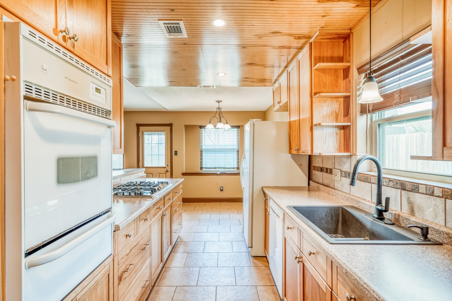 21611 Glenbranch Drive Spring, TX 77388 - Photo 3 of 15 a kitchen with a stove a sink and a refrigerator