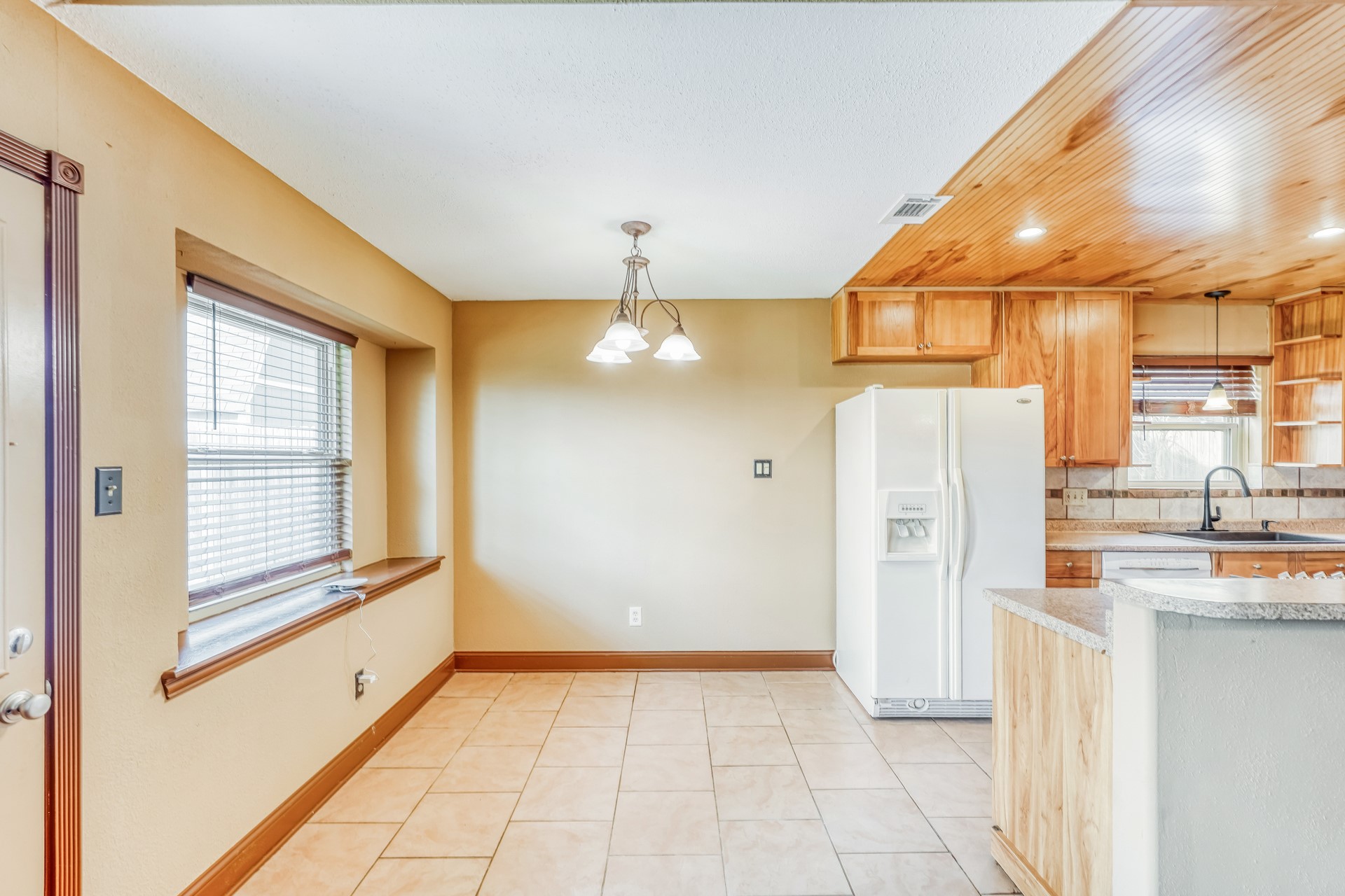 21611 Glenbranch Drive Spring, TX 77388 - Photo 4 of 15 a view of a kitchen with a refrigerator and a window