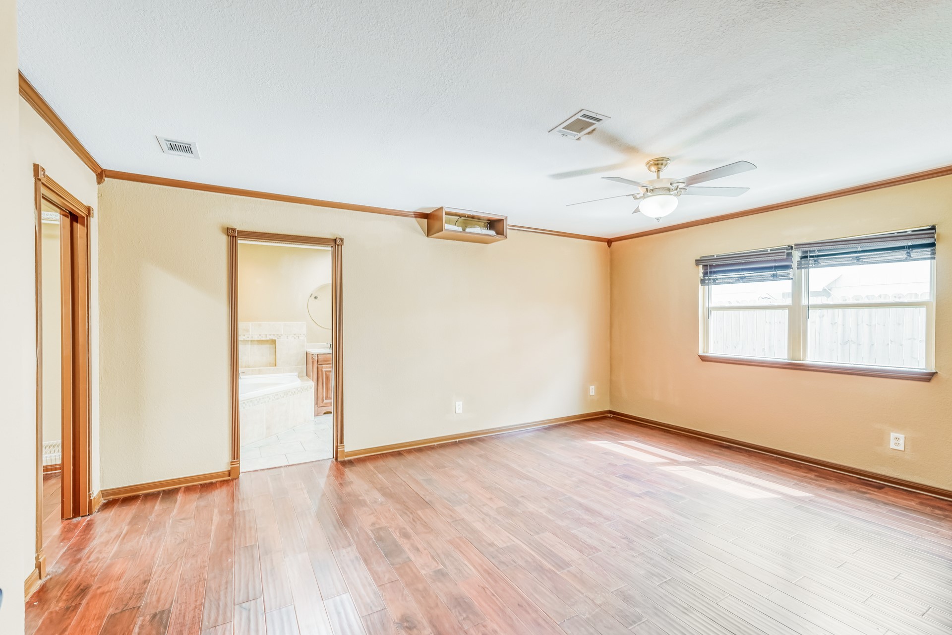21611 Glenbranch Drive Spring, TX 77388 - Photo 8 of 15 a view of an empty room with wooden floor and a window
