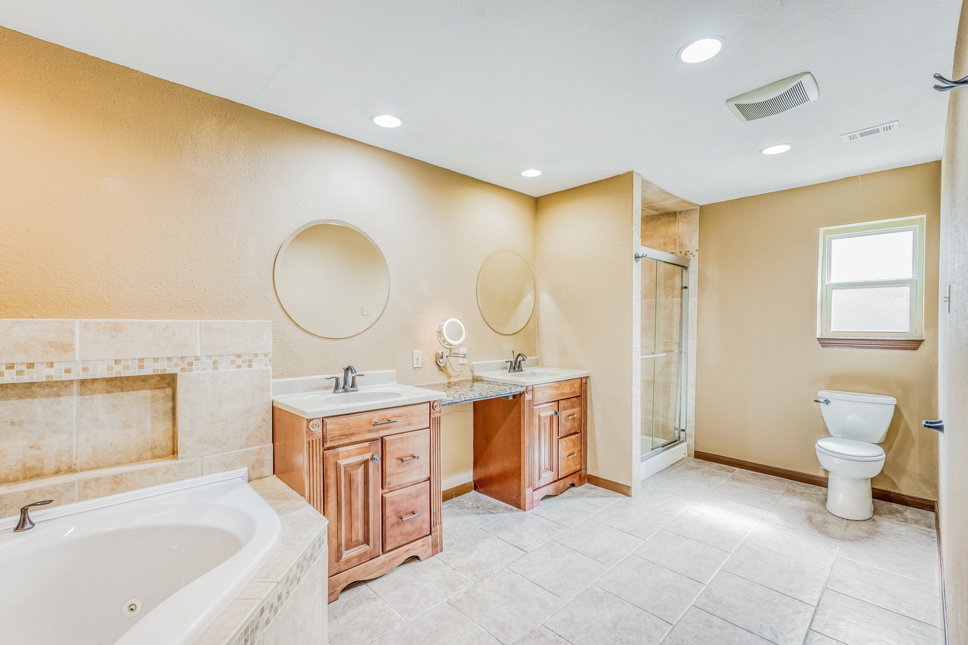 21611 Glenbranch Drive Spring, TX 77388 - Photo 9 of 15 a spacious bathroom with a double vanity sink a mirror and a bathtub