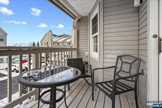 a view of a balcony with a table and chairs