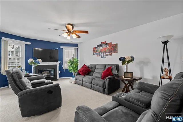 a living room with furniture a fireplace and a chandelier