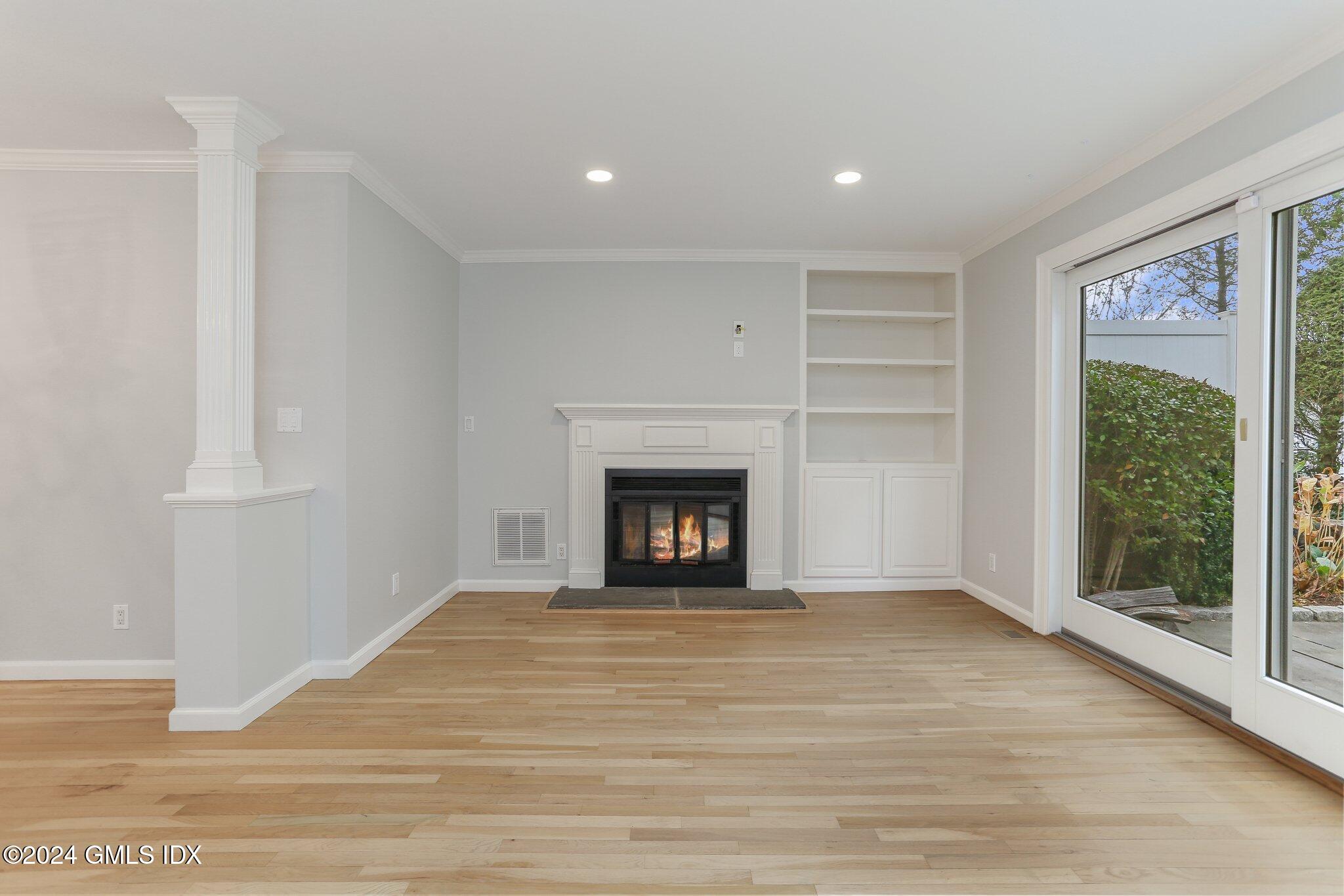 53 Bible Street, Unit 4 Cos Cob, CT 06807 - Photo 12 of 28 a view of an empty room with a window and fire place