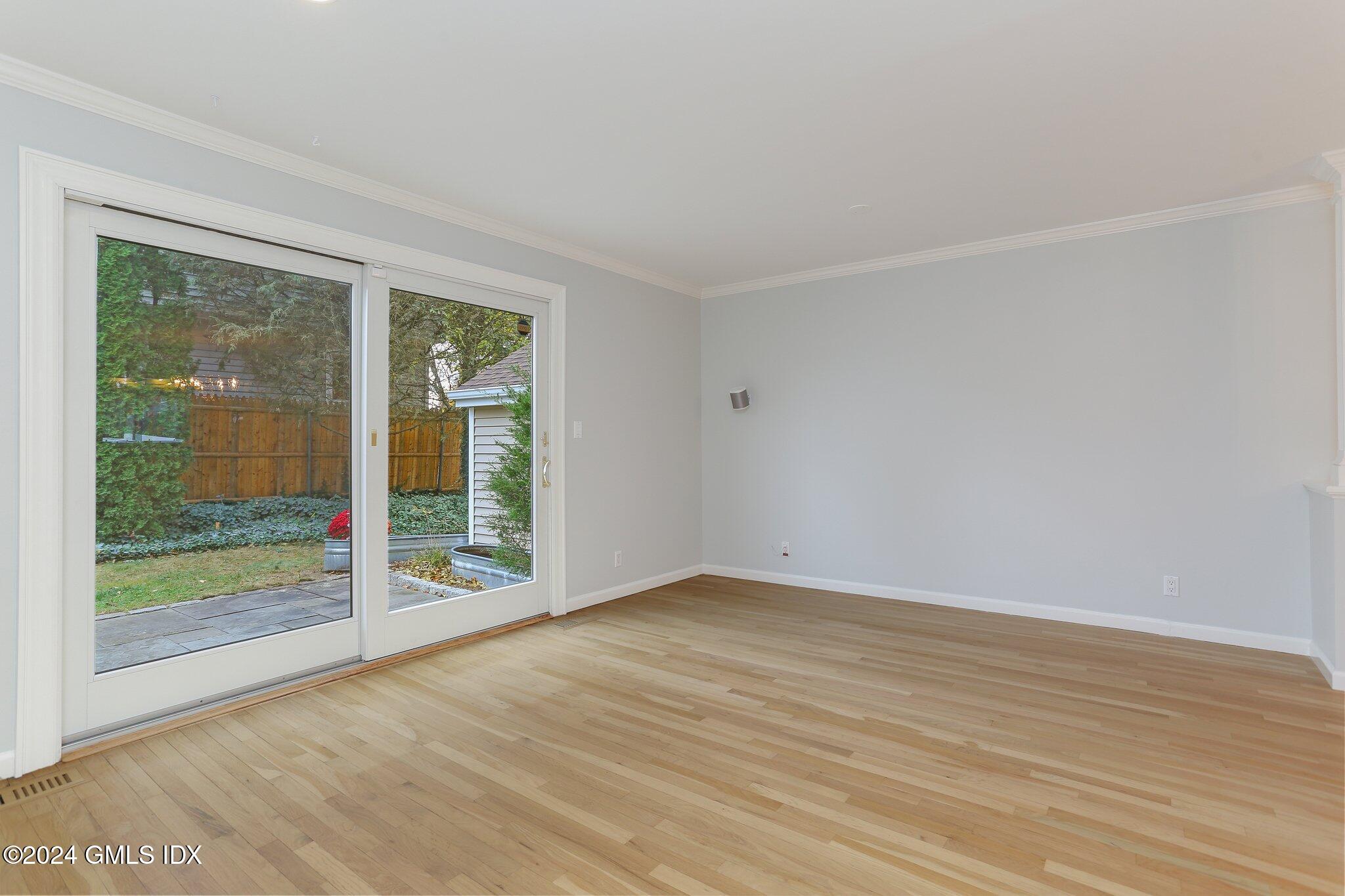 53 Bible Street, Unit 4 Cos Cob, CT 06807 - Photo 13 of 28 a view of an empty room with wooden floor and a window