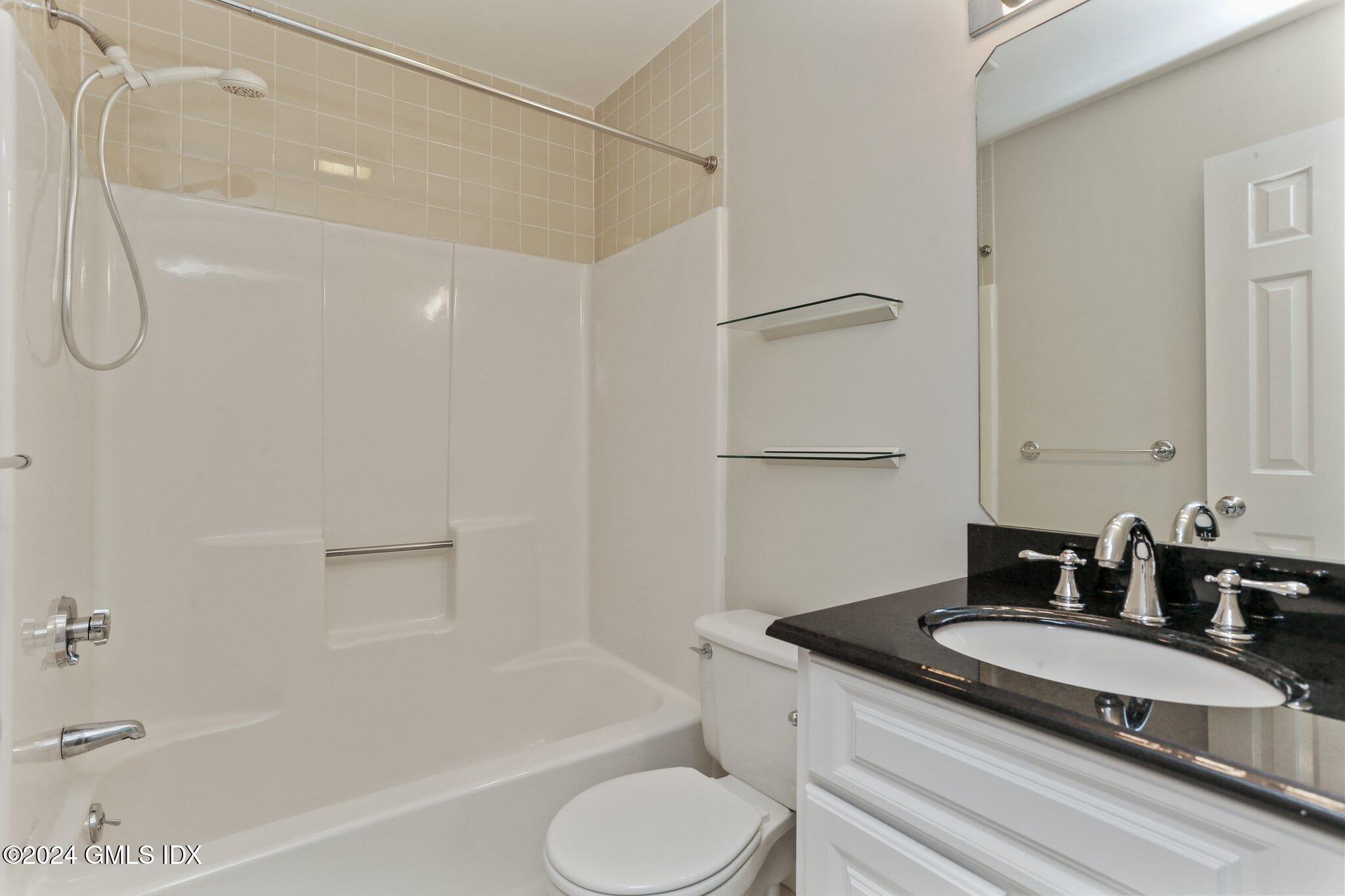 53 Bible Street, Unit 4 Cos Cob, CT 06807 - Photo 18 of 28 a bathroom with a granite countertop sink toilet and shower