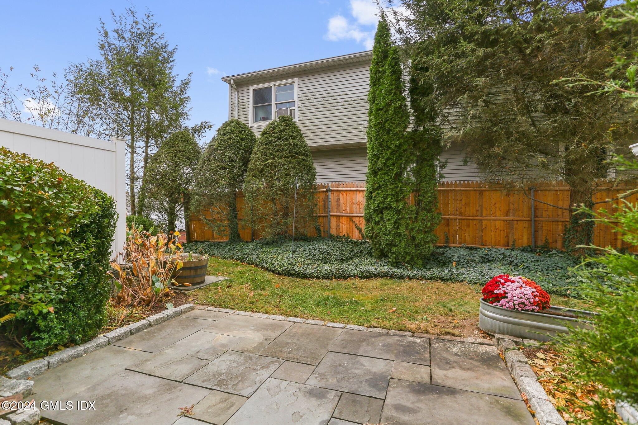 53 Bible Street, Unit 4 Cos Cob, CT 06807 - Photo 19 of 28 a view of a backyard with potted plants