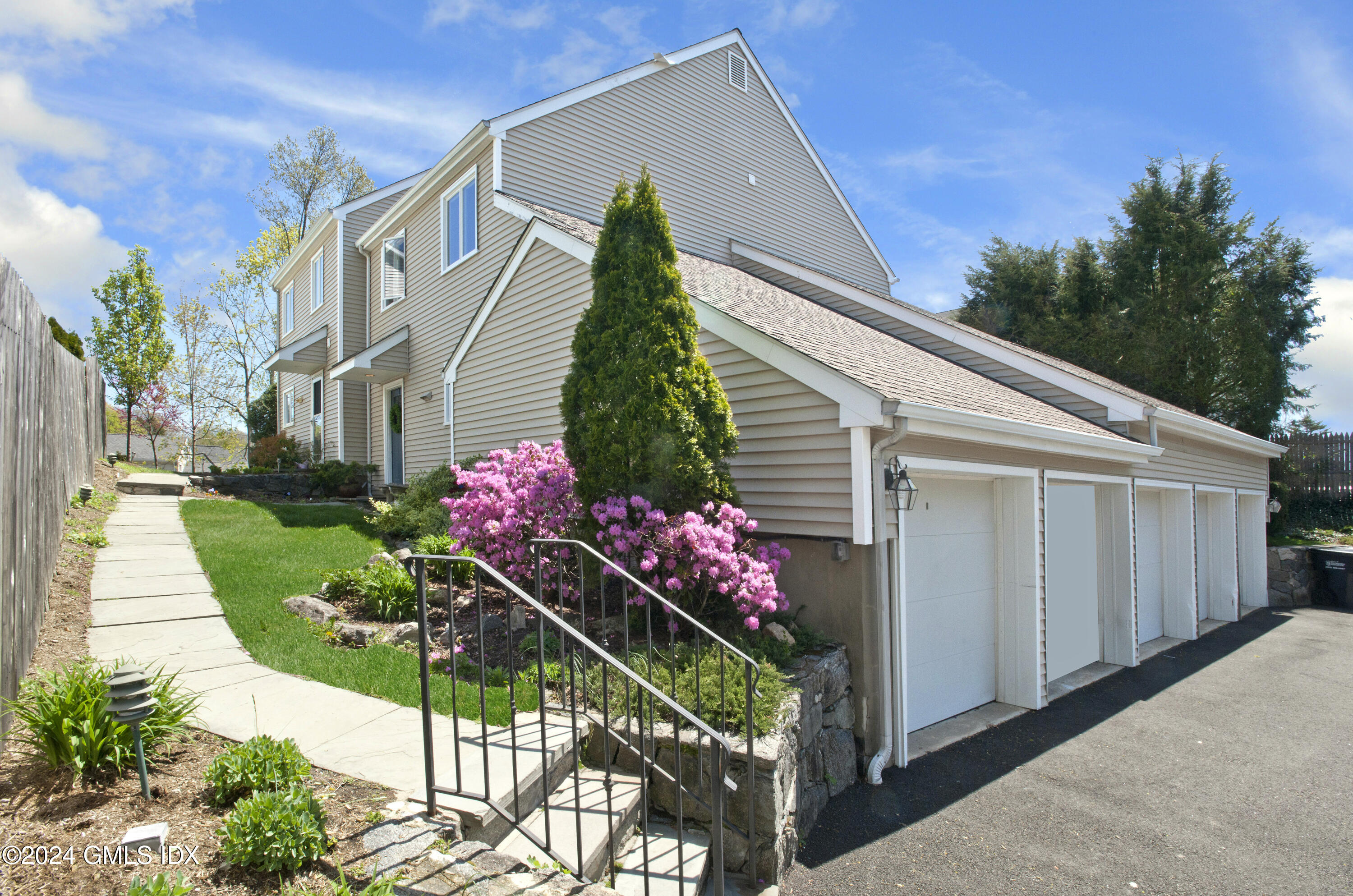 53 Bible Street, Unit 4 Cos Cob, CT 06807 - Photo 2 of 28 a front view of a house with a yard
