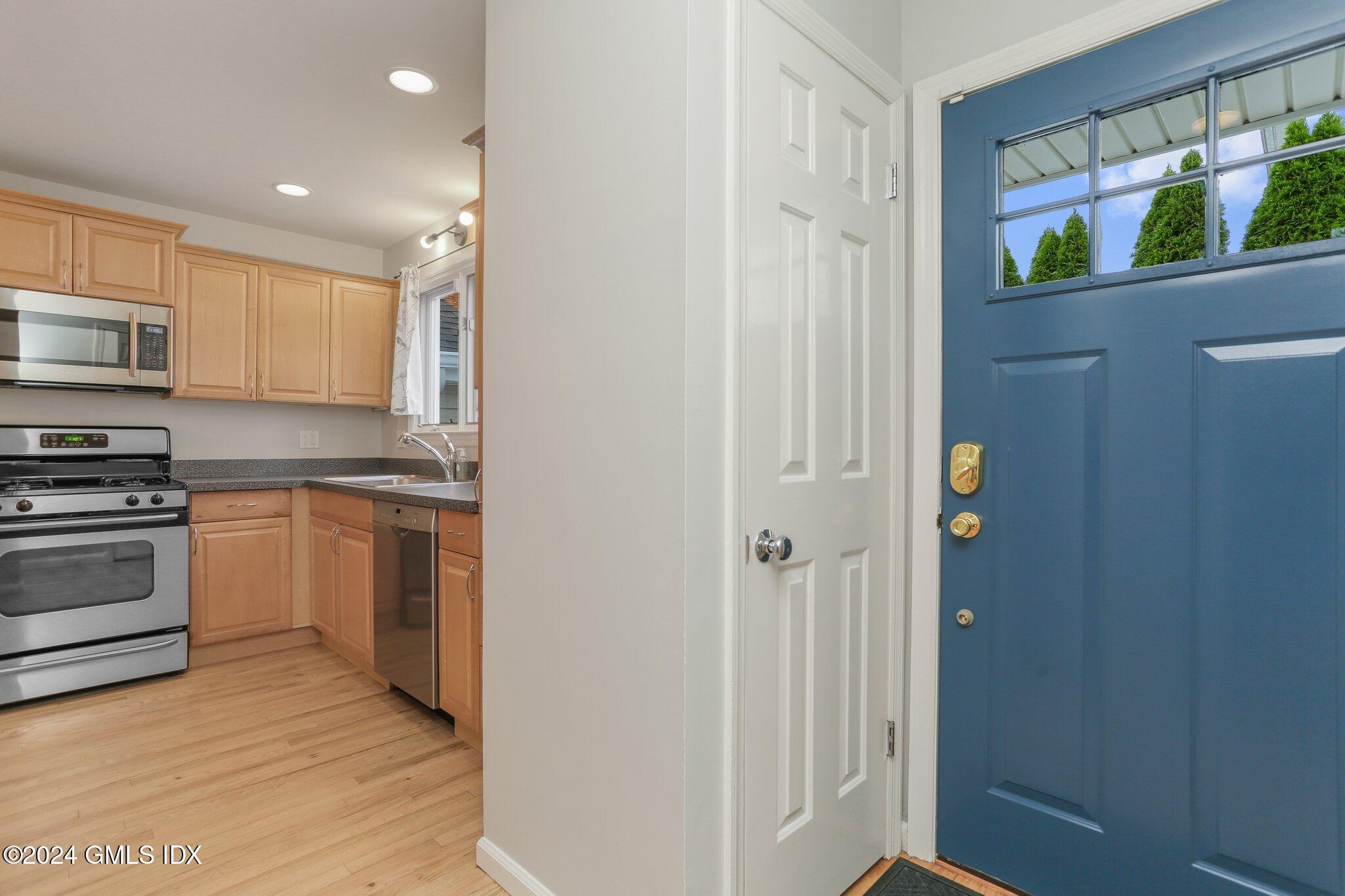 53 Bible Street, Unit 4 Cos Cob, CT 06807 - Photo 3 of 28 a kitchen with stove cabinets and entryway