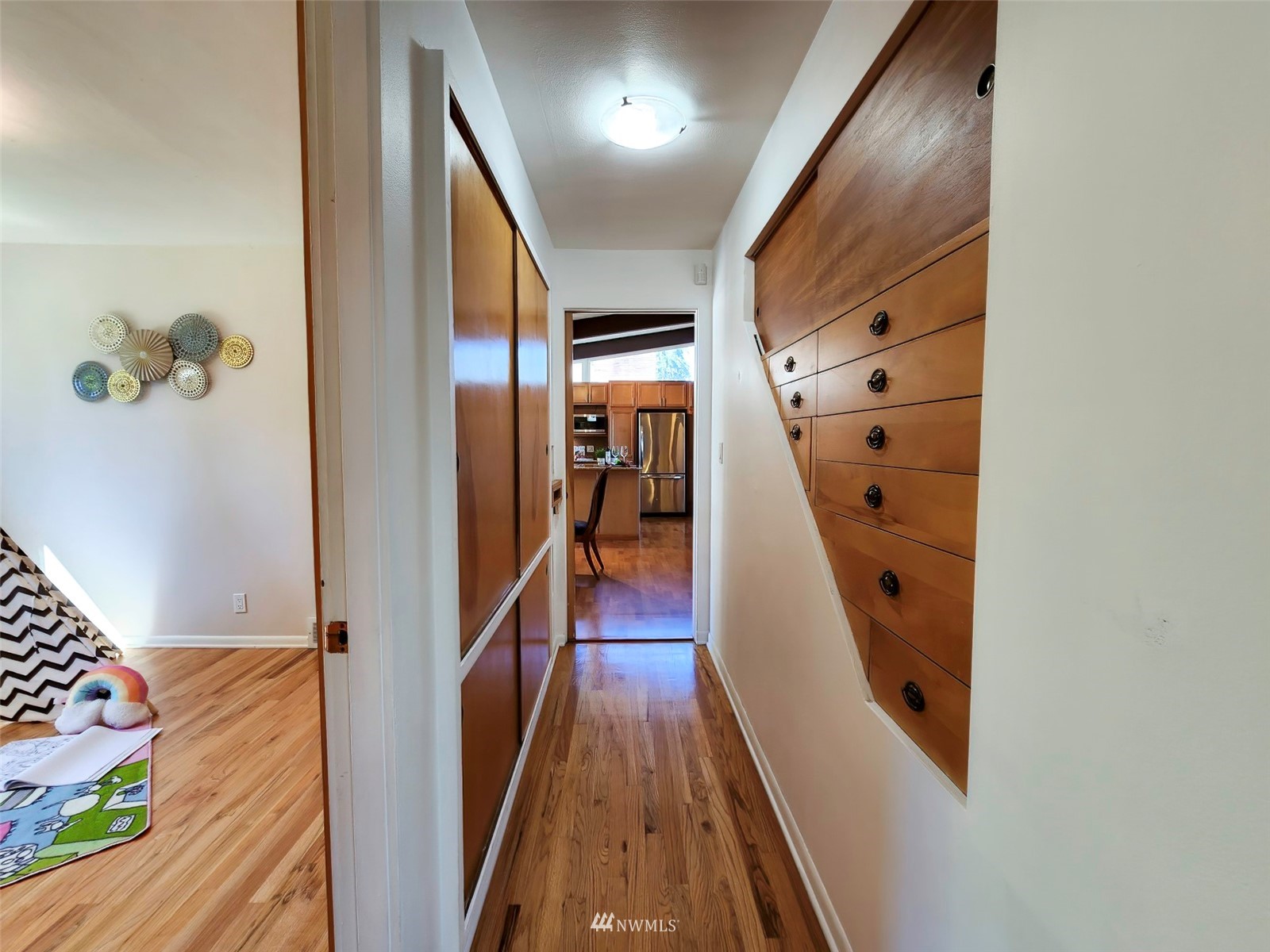7133 South Sunnycrest Road Seattle, WA 98178 - Photo 24 of 39 a view of a hallway with wooden floor and stairs