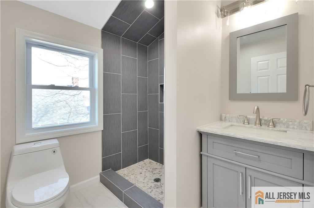 24 John Street Helmetta, NJ 08828 - Photo 17 of 18 a bathroom with a granite countertop sink toilet and shower