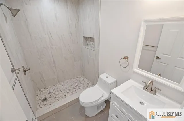 a bathroom with a sink a toilet and shower curtain