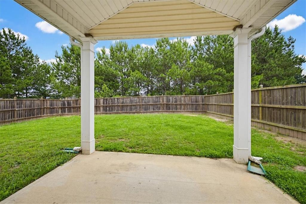 314 Boulder Run Hiram, GA 30141 - Photo 26 of 31 a view of a backyard with a big yard potted plants and large tree
