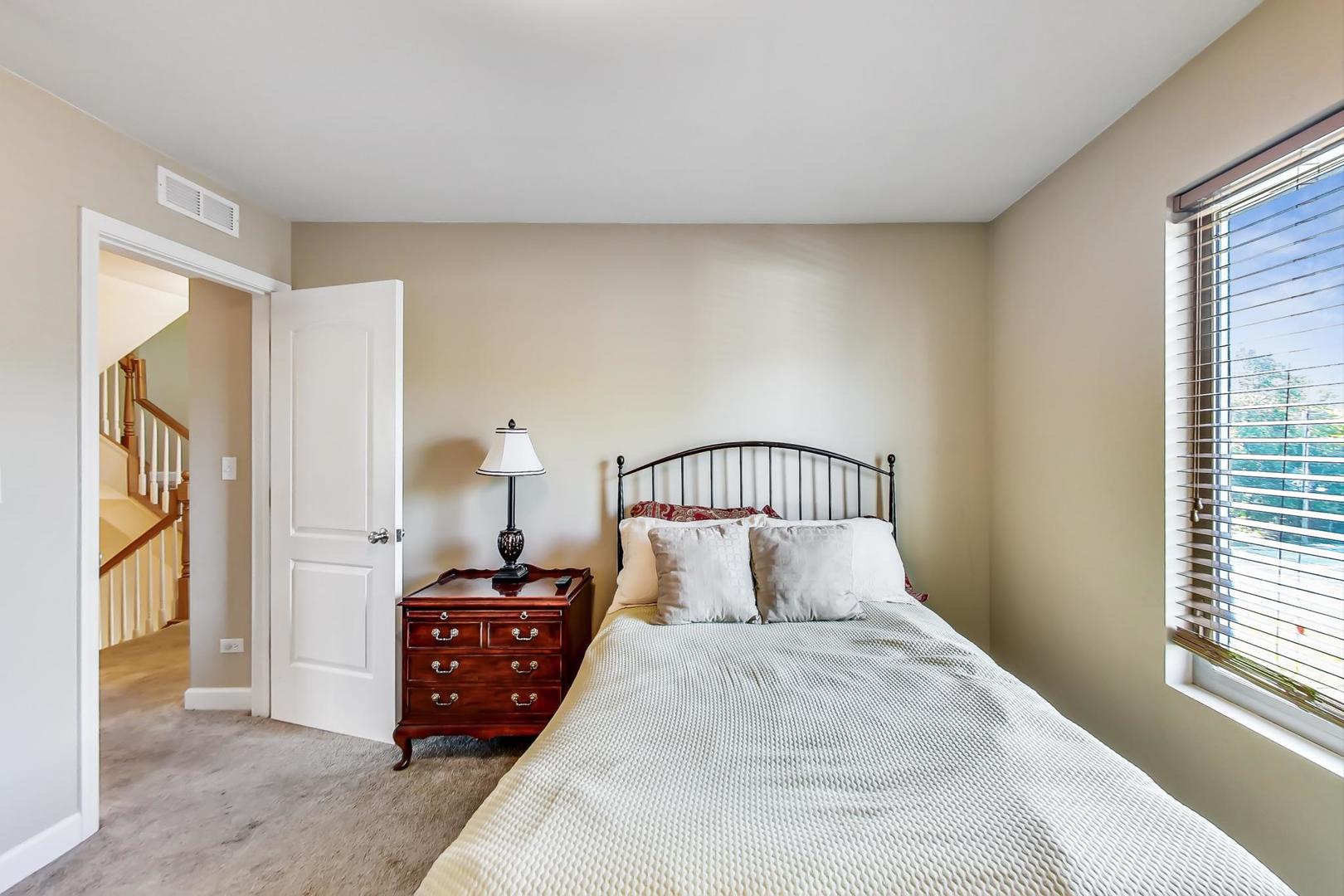 7312 Ogden Avenue Riverside, IL 60546 - Photo 21 of 38 a bedroom with a bed and a window
