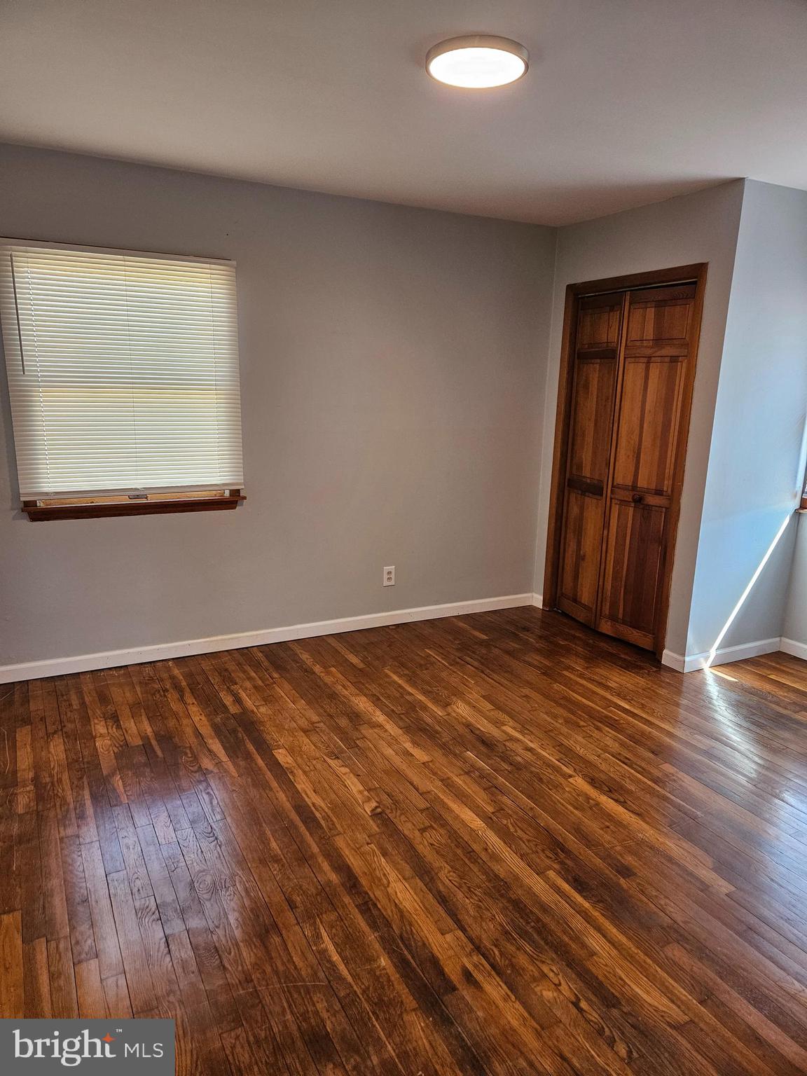 29 Malvern Road Newark, DE 19713 - Photo 6 of 14 a view of an empty room with wooden floor and a window
