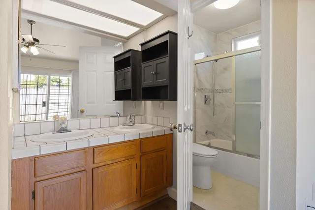a bathroom with a sink a toilet and shower