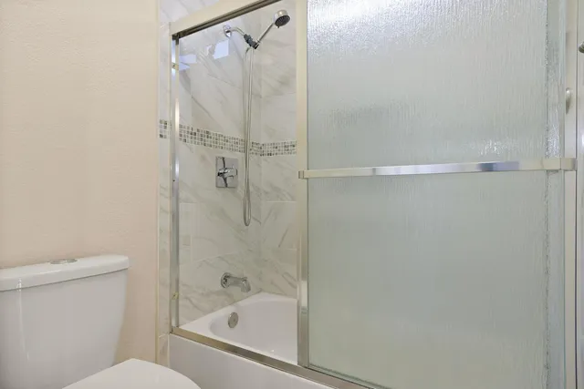 a bathroom with a bathtub and a toilet