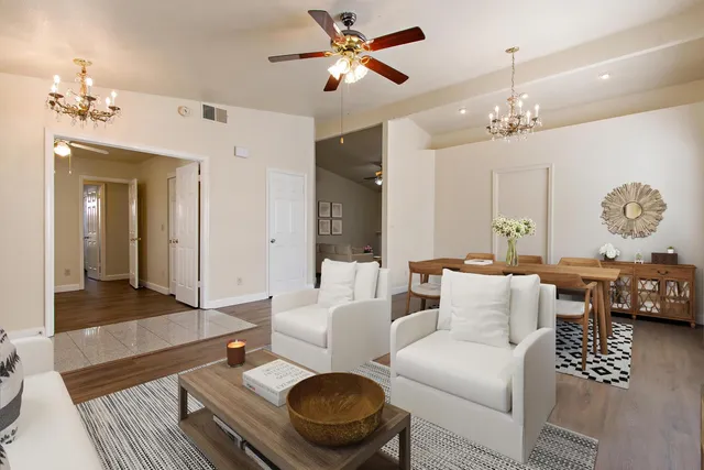 a living room with furniture a chandelier and a chandelier
