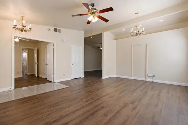 a view of a chandelier fan and entryway