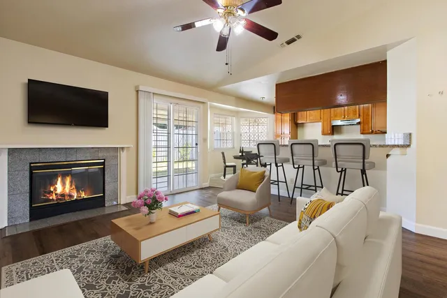 a living room with furniture fireplace and flat screen tv