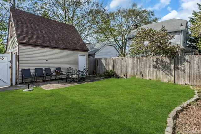 a view of a backyard with sitting area