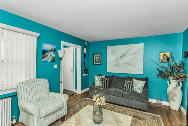 a living room with furniture and a potted plant