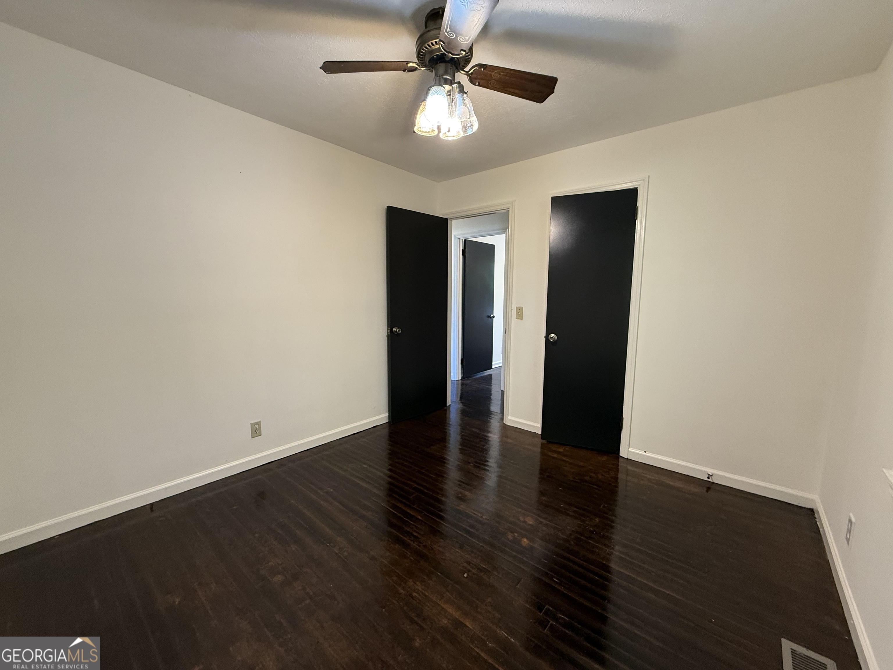 179 Youngs Mill Road LaGrange, GA 30241 - Photo 21 of 30 an empty room with wooden floor and ceiling fan