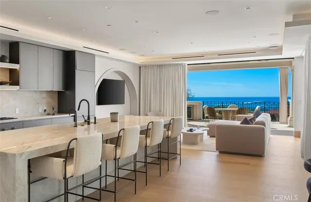 a living room with fireplace furniture and a large window
