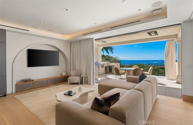 a living room with furniture and large windows