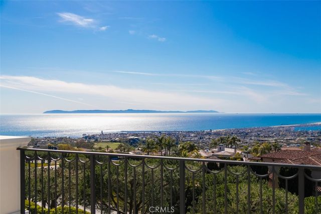 a view of a balcony with furniture and a chandelier