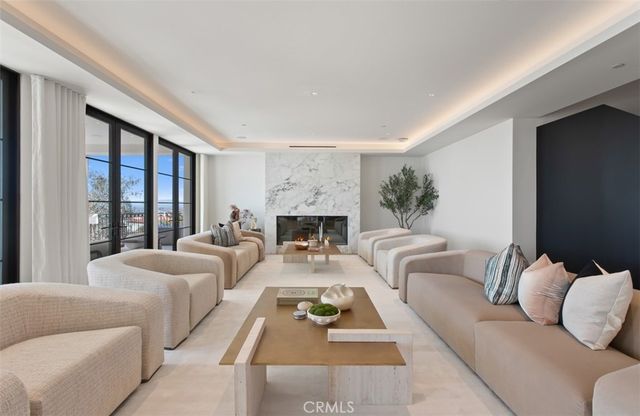 a spacious bedroom with a bed and a chandelier