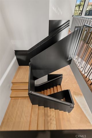 a living room with furniture a flat screen tv and a floor to ceiling window