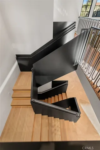 a living room with furniture a flat screen tv and a floor to ceiling window