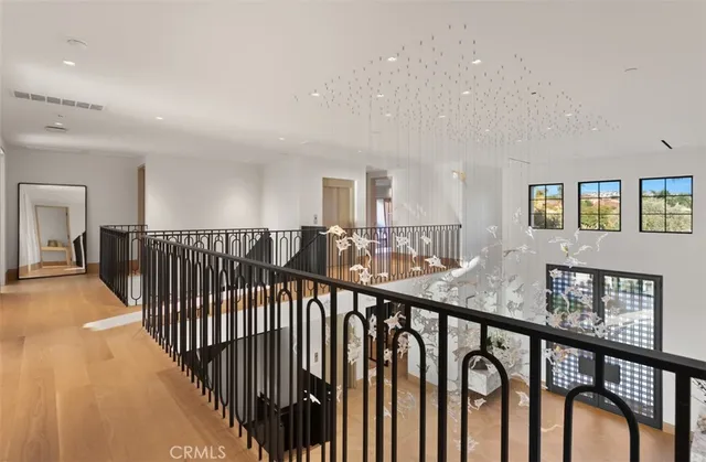 a bedroom with a bed and large windows