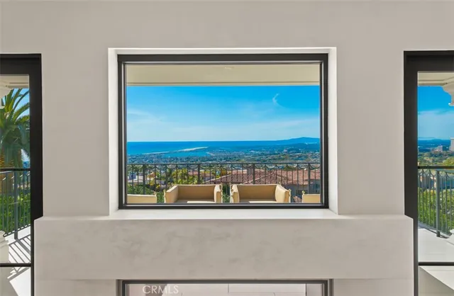 a living room with furniture a flat screen tv and a window