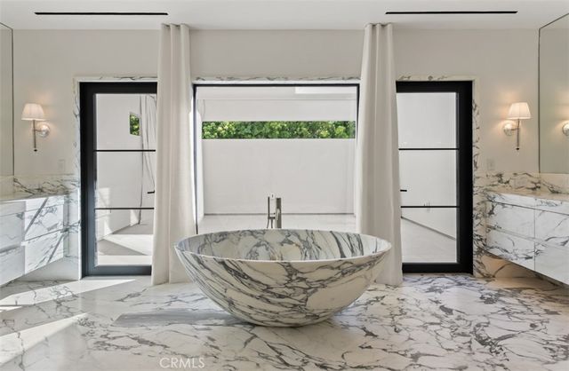 a bathroom with a granite countertop sink a toilet and a mirror