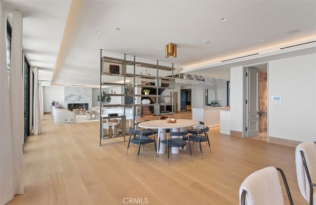 a living room with stainless steel appliances kitchen island granite countertop furniture and a fireplace