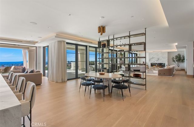 a large kitchen with stainless steel appliances a stove a sink dishwasher and a refrigerator with wooden floor